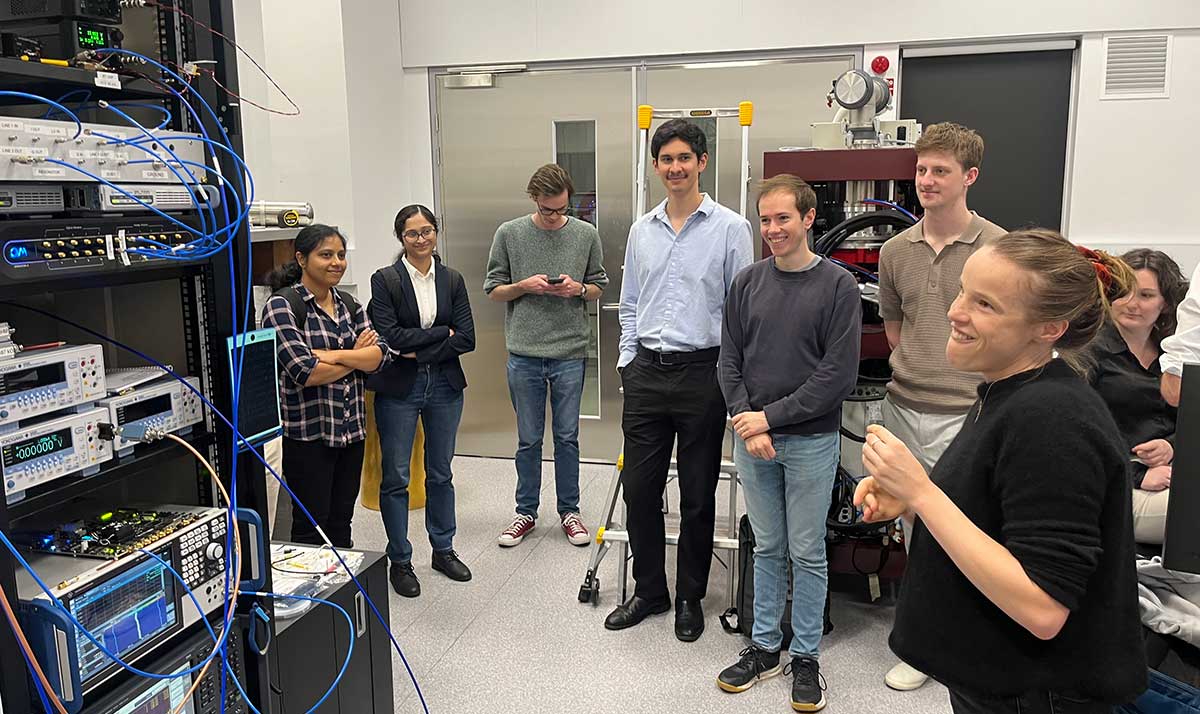 An image of Dr Xanthe Croot showing students and visitors around the SQCL laboratory
