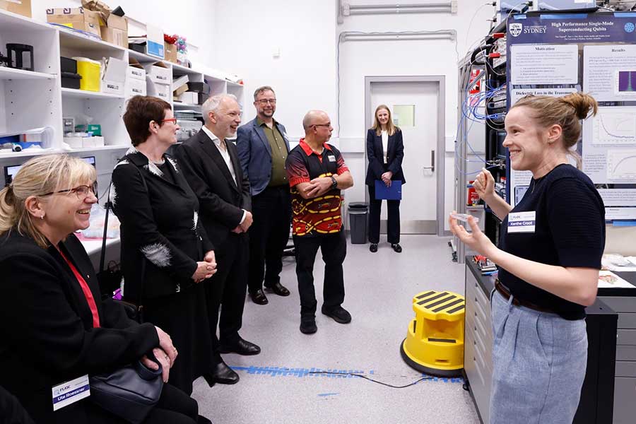 Dr Xanthe Croot taking guests at the official FliCQ launch on a tour of the Superconducting Quantum Circuits Laboratory