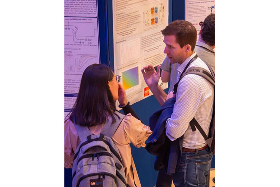 A photo of A/Prof John Bartholomew speaking with another attendee at WQRN 2026