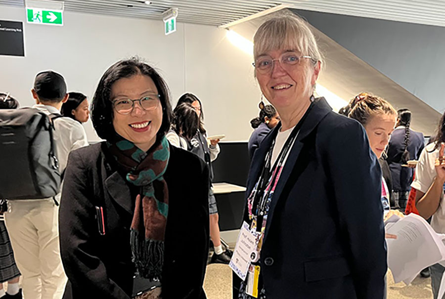 Prof Anita Ho-Baillie and Prof Helen Johnston mingling with students and teachers over morning tea